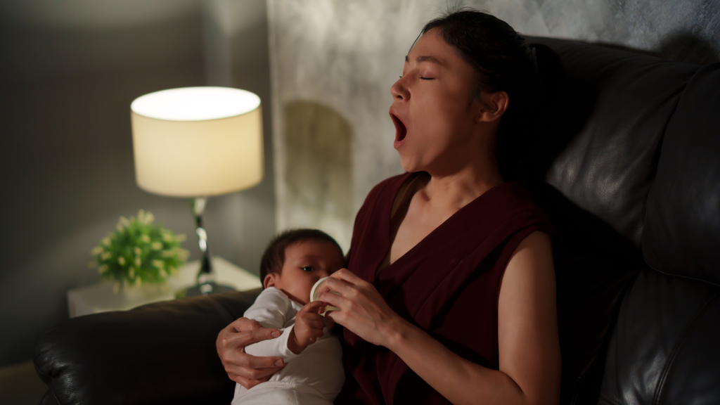 A Sister Expected Free Babysitting Every Day After Work, But Her Request Sparked A Fight When The Baby’s Aunt Finally Said No sleepy mom yawning while bottlefeeding baby