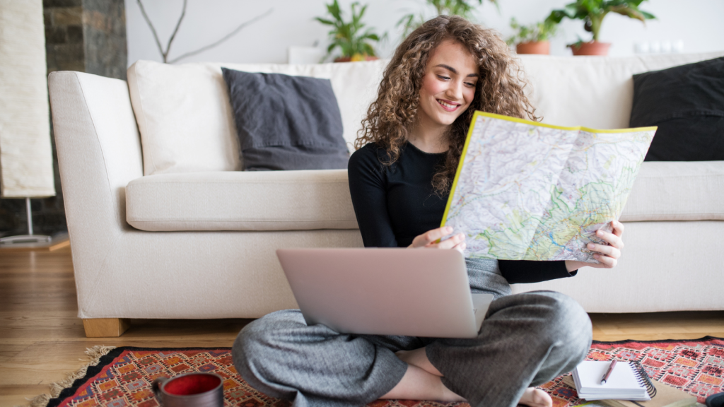 smiling young woman planning a trip with map in hand