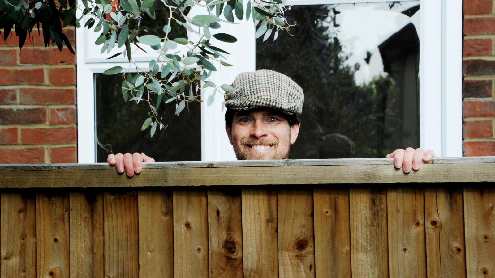 His Neighbor Won’t Stop Snooping Around His Yard—Even After He’s Told Him to Stay Out man looking over a fence