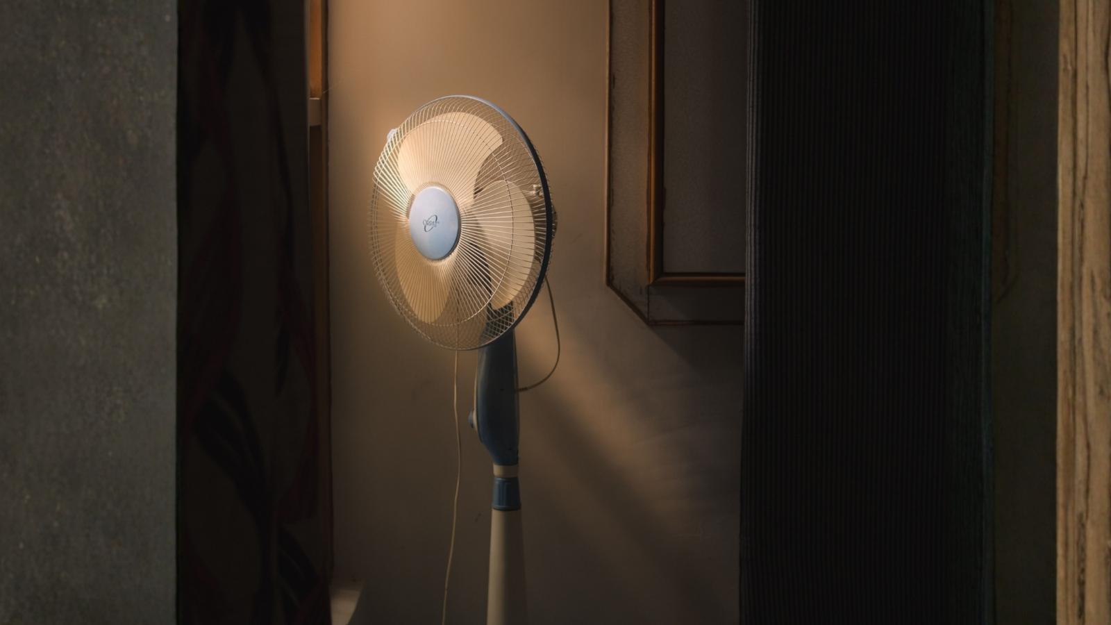 standing fan in moody lighting