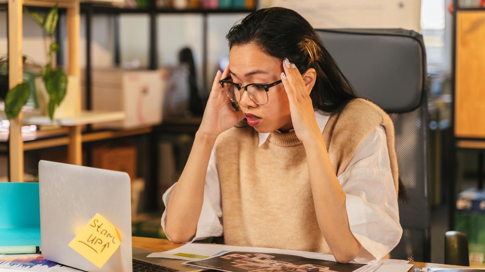 New Graduate Questions Whether A Toxic Company Who Overworked Her Deserves Her Best Work Before She Quits For A Better Job stressed corporate employee looking frazzled