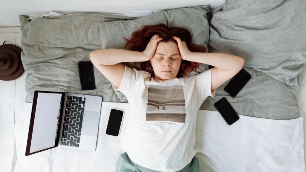 stressed woman laying on her bed