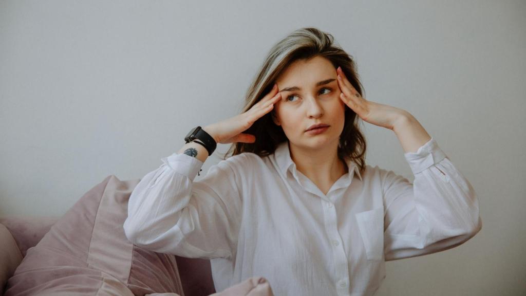 stressed woman putting hands on head