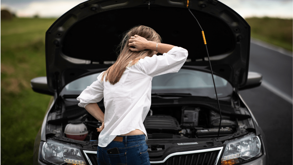 stressed woman with car hood up