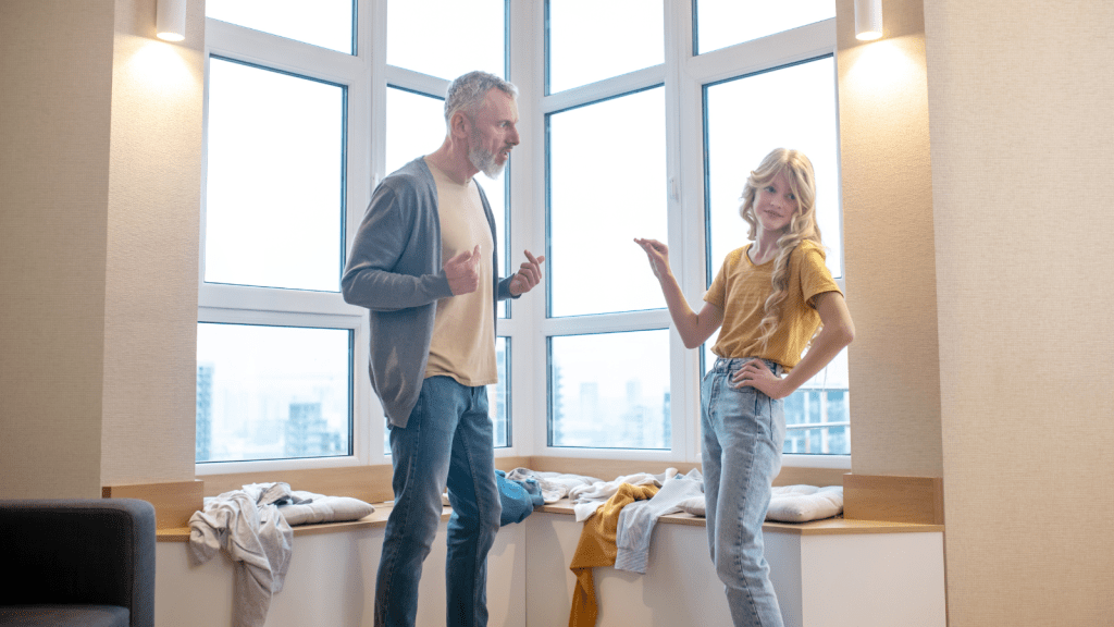 teen girl arguing with dad in apartment