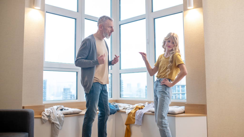 teen girl arguing with dad in apartment