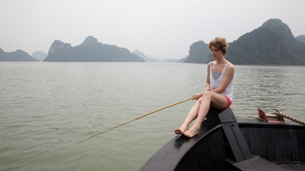 teen girl fishing in a boat