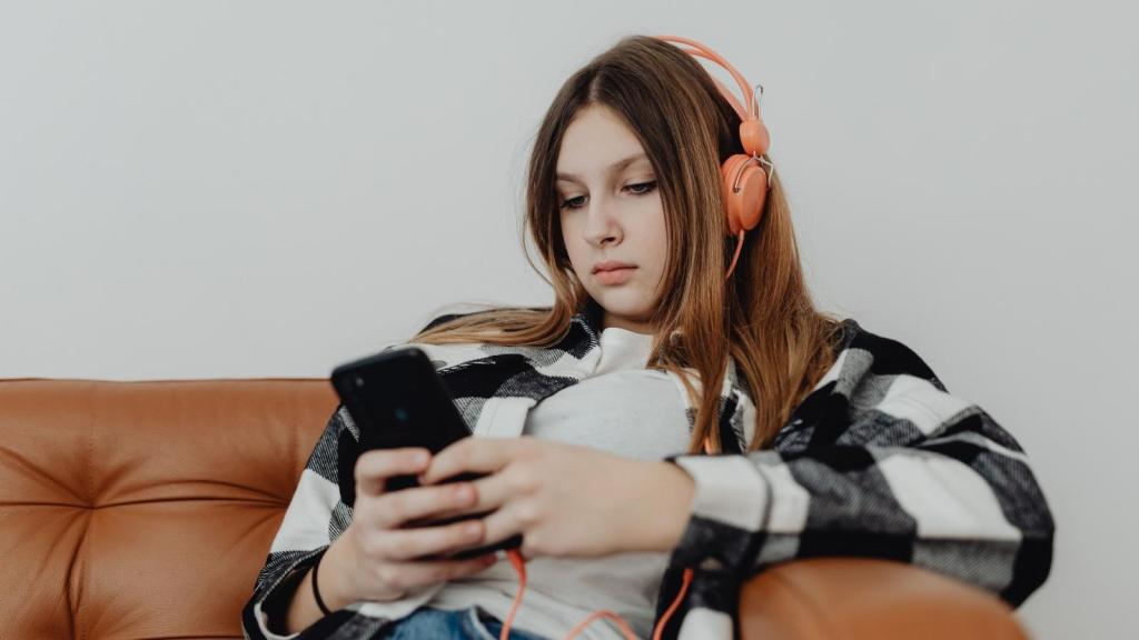 teenager typing on her smartphone