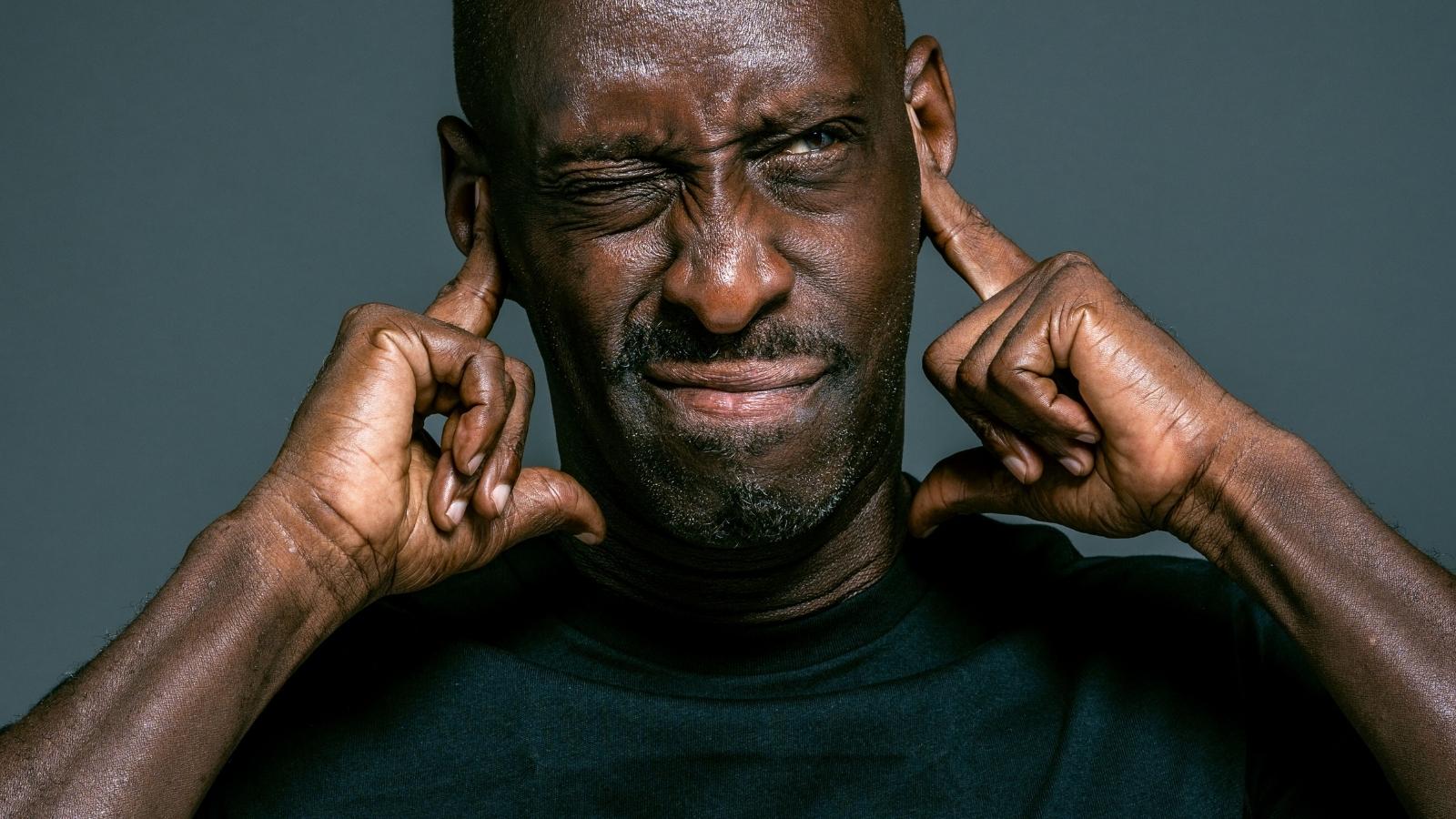 The Barking Next Door Never Seems to Stop. Hes Reaching a Point Where Hes Not Sure How Much Longer He Can Endure It ticked man covering his ears from loud sound