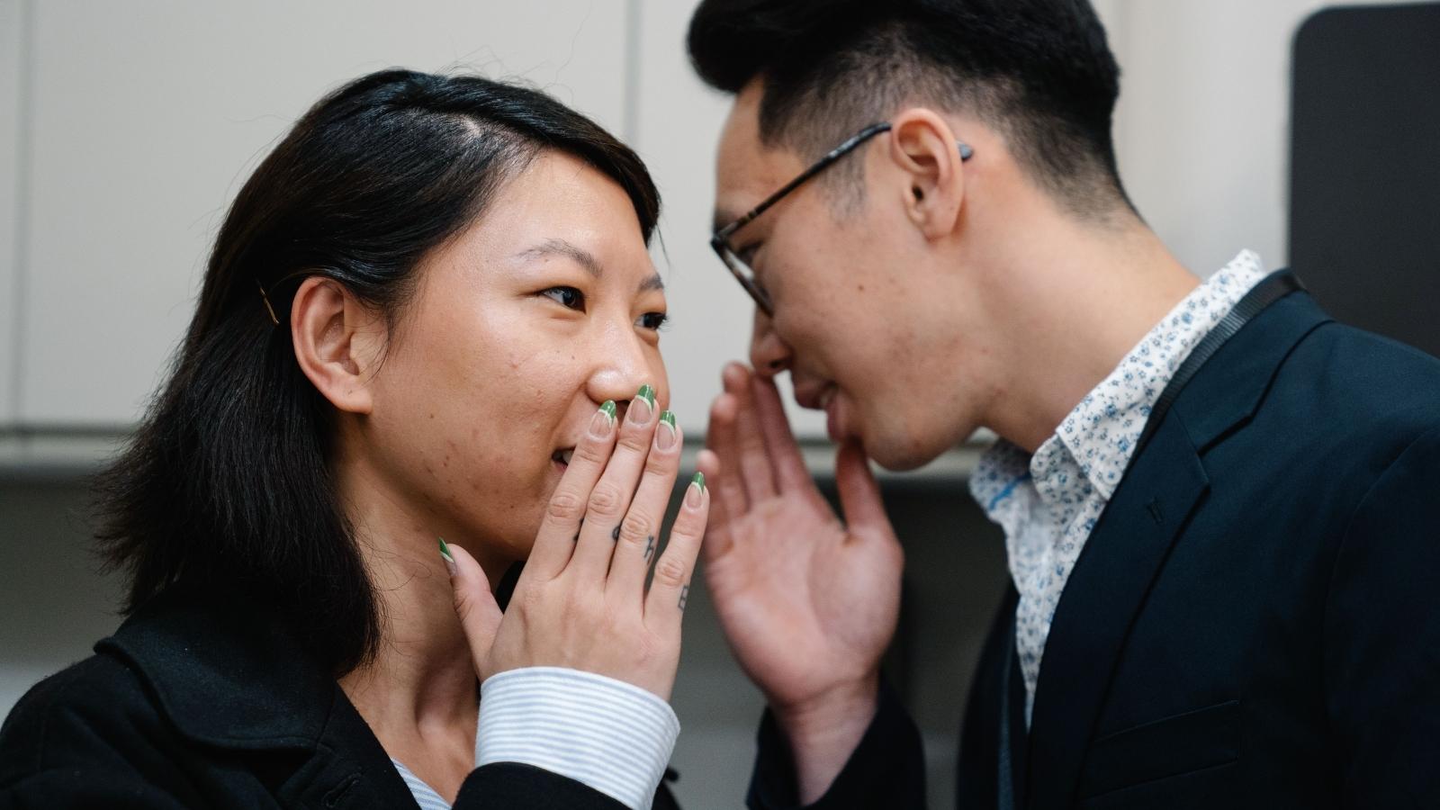 She Stayed Quiet About An Office Joke—Now Her Coworker Feels Betrayed two employees gossipining