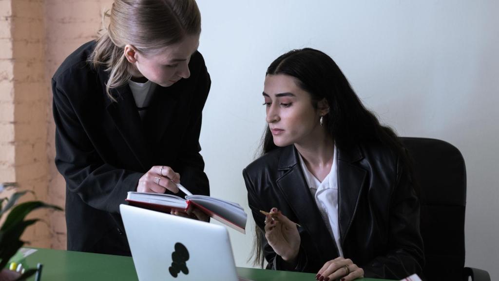 two women working together