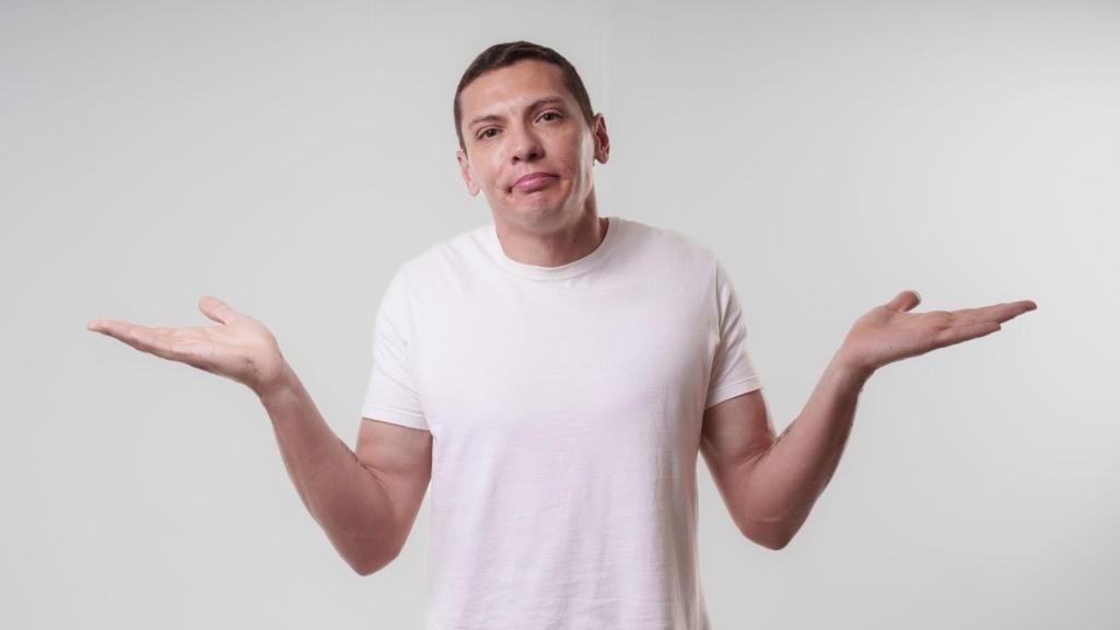 upset man in white shirt shrugging