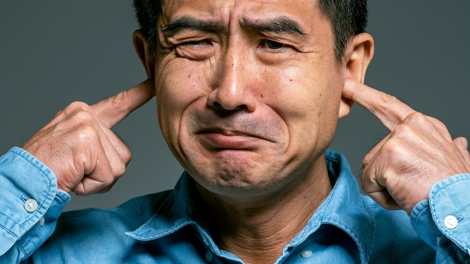 A Business Owner Has Begged The Gym Next Door To Quiet Down. They Wont Listen. upset man plugging his ears