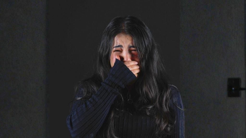 upset woman crying in gray sweater