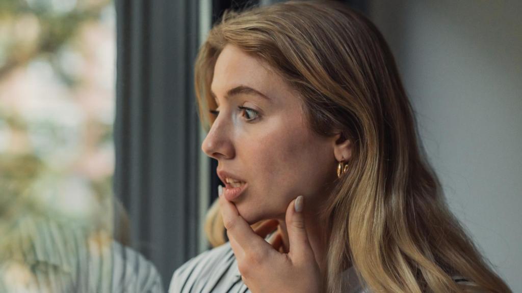 woman looking out a window