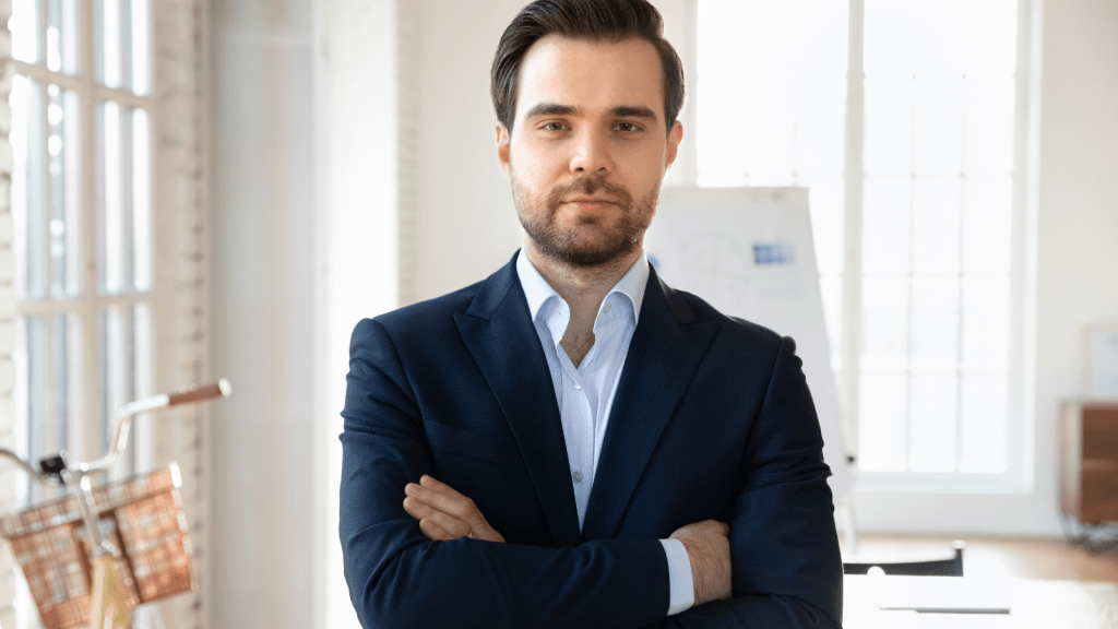well dressed young man folding arms