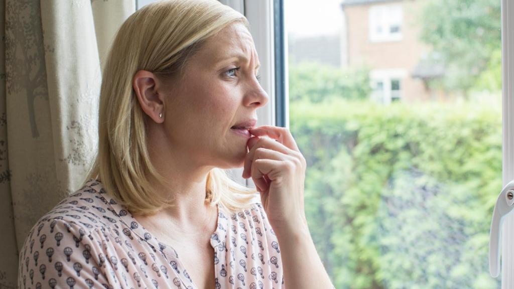 woman looking out a window