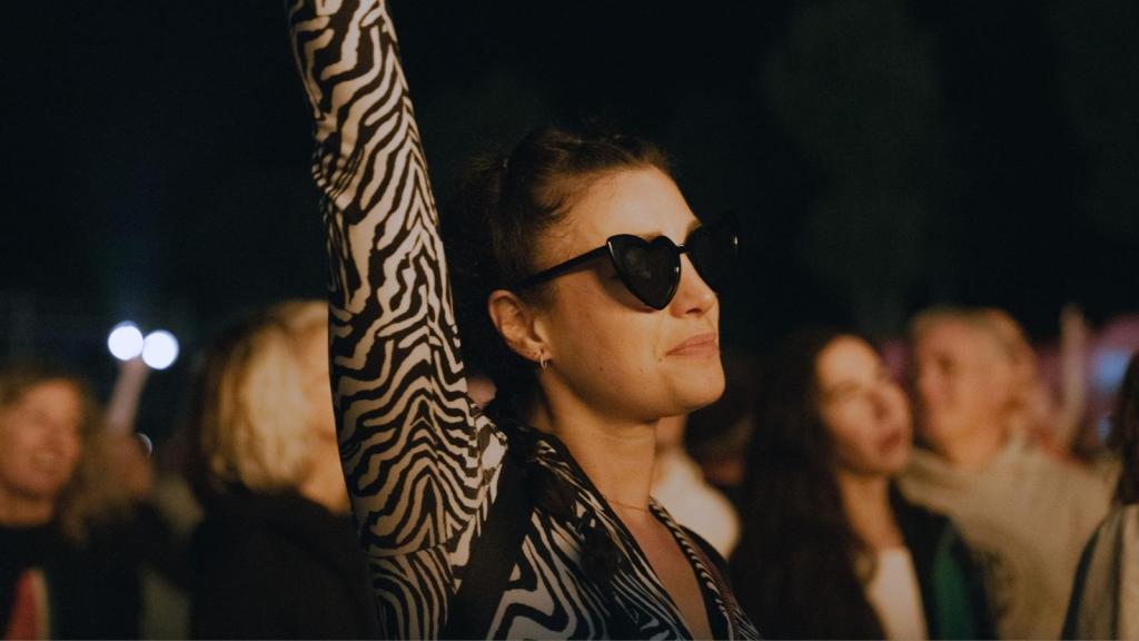 woman at a concert in heart shaped sunglasses
