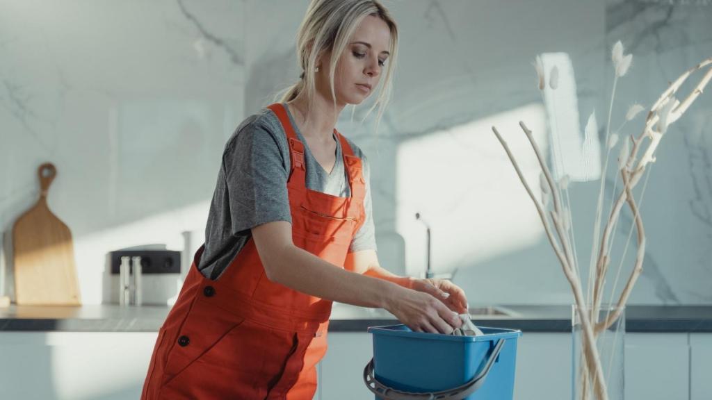 woman cleaning in orange overalls