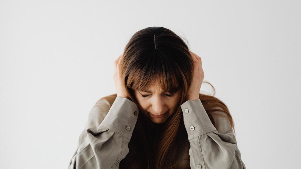 woman covering ears from loud sound
