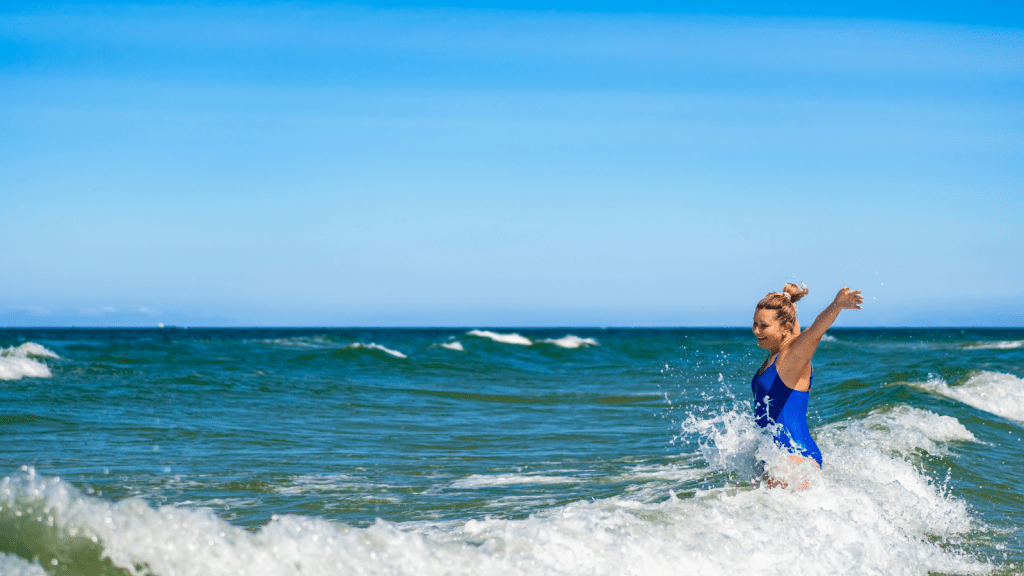 woman having fun in the ocean waves