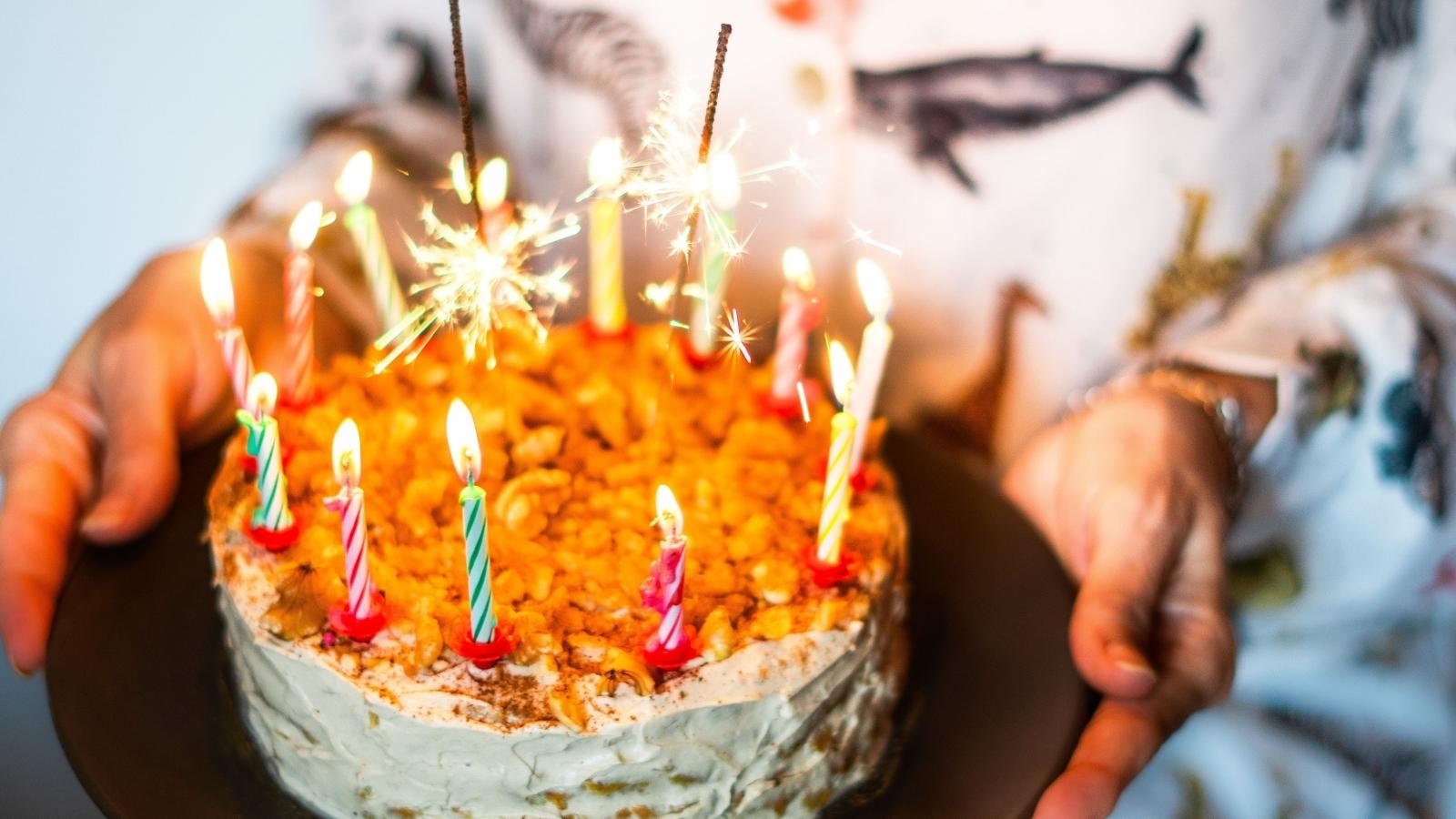 Womans Family Celebrated An Ex Brother In Laws Birthday, So Her Selfish Sister Made It About Her Own Hurt Feelings woman holding cake with candles