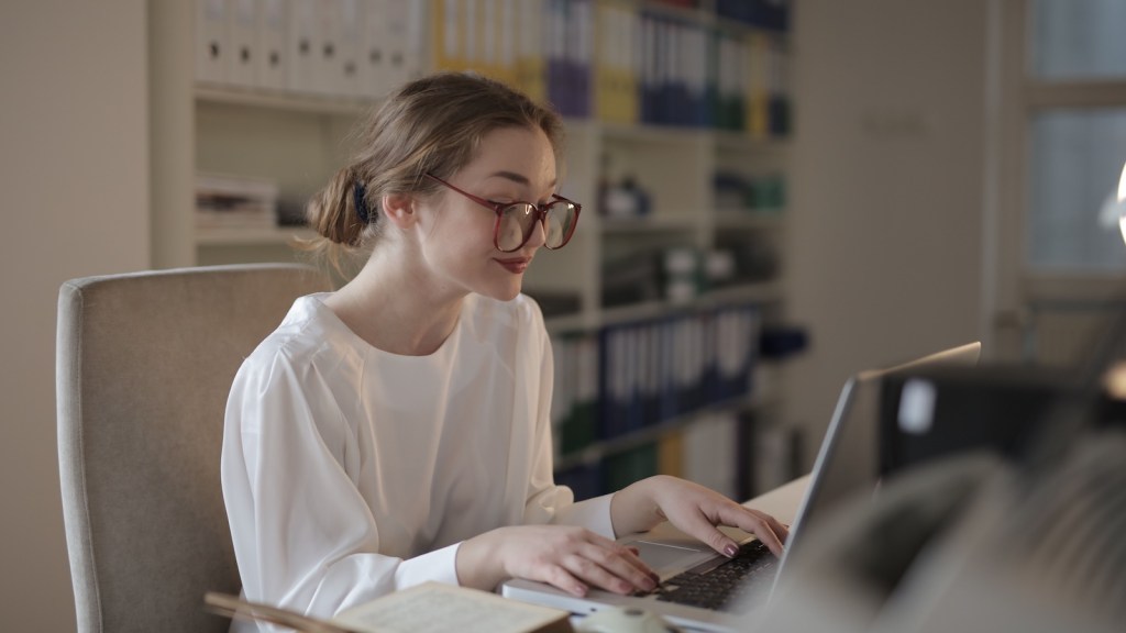 woman wearing glasses on computer
