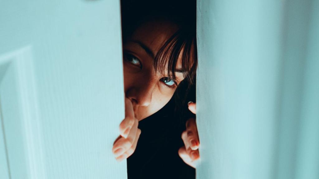 woman peaking through door