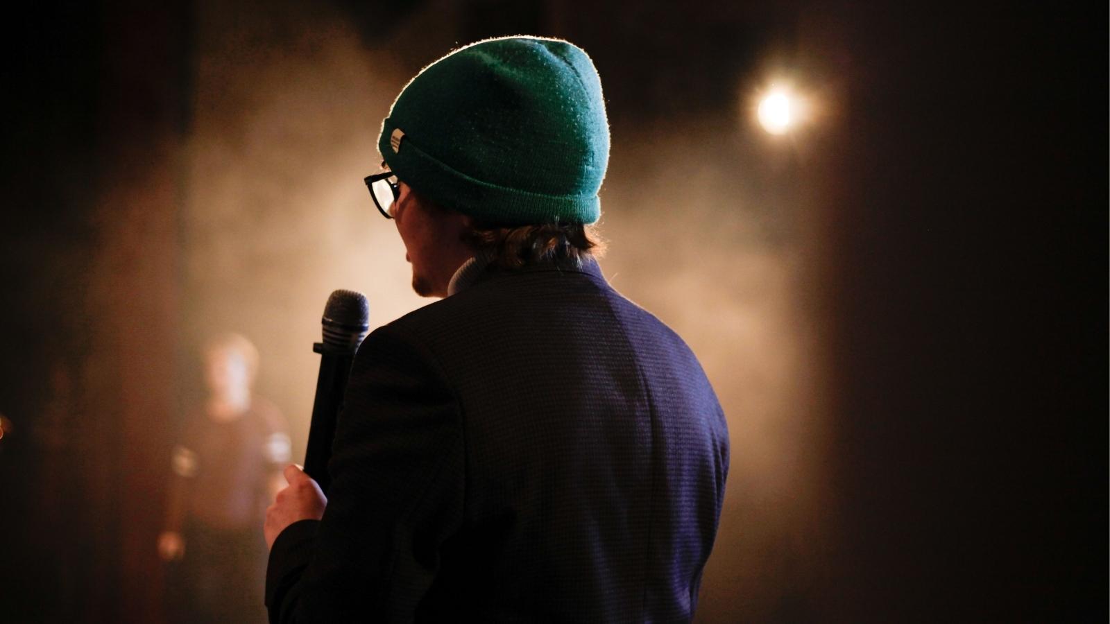 She Shared an Embarrassing Secret in Confidence. Then She Watched Her Friend Tell It to a Room Full of Strangers. woman performing at a standup show