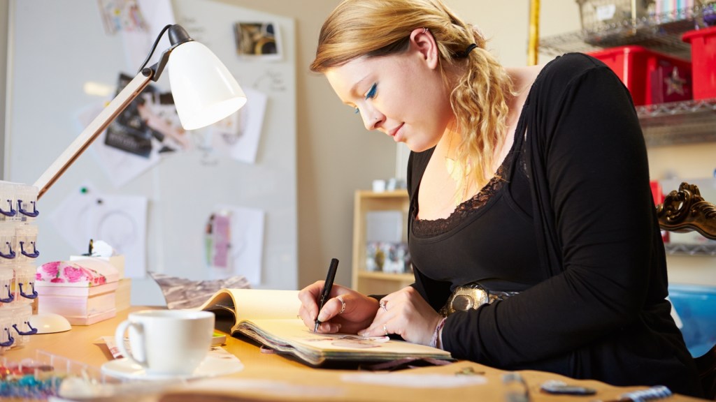 woman scrapbooking at desk