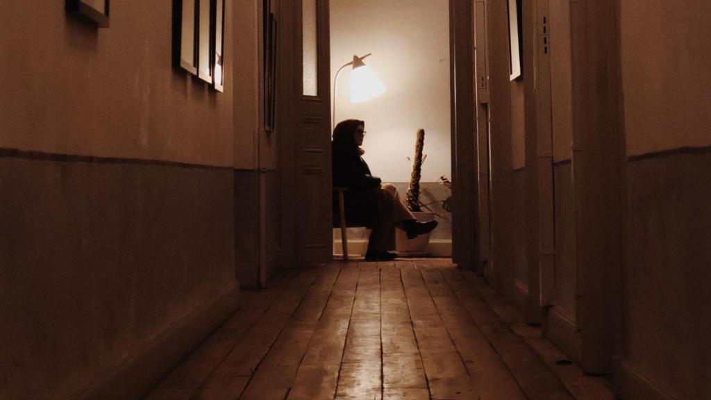 woman sitting in apartment hallway