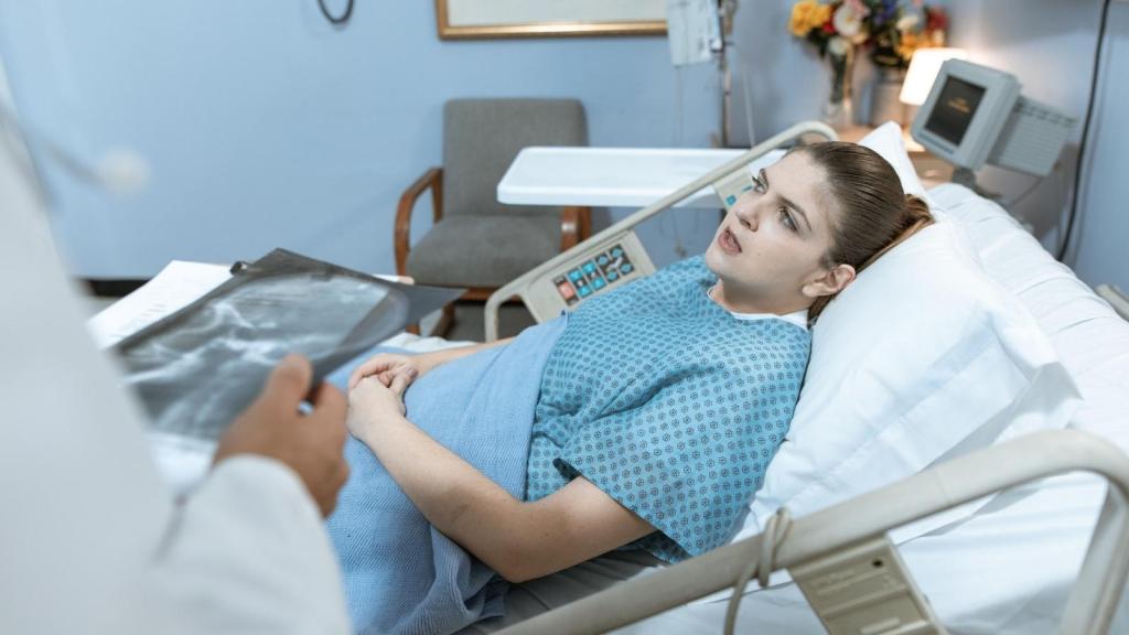 woman speaking to doctor in hospital