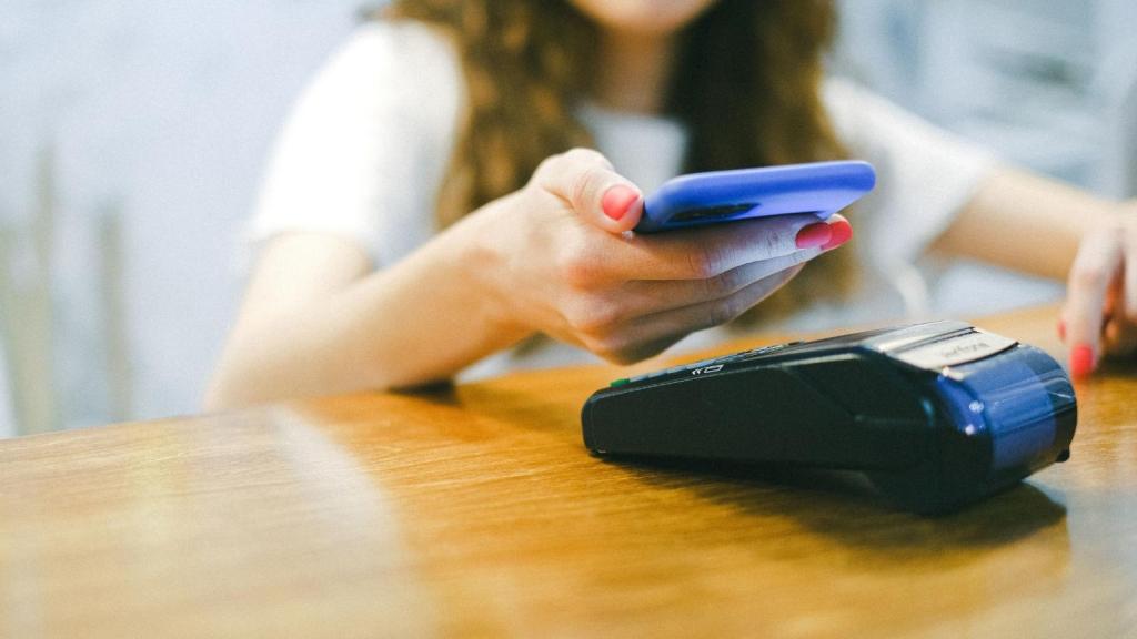 woman tapping to pay card