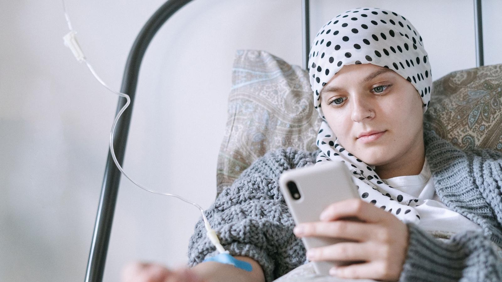 She Left Her Life Behind to Help Her Sibling Fight Cancer—Then Faced Resistance She Never Expected. woman with cancer laying in bed