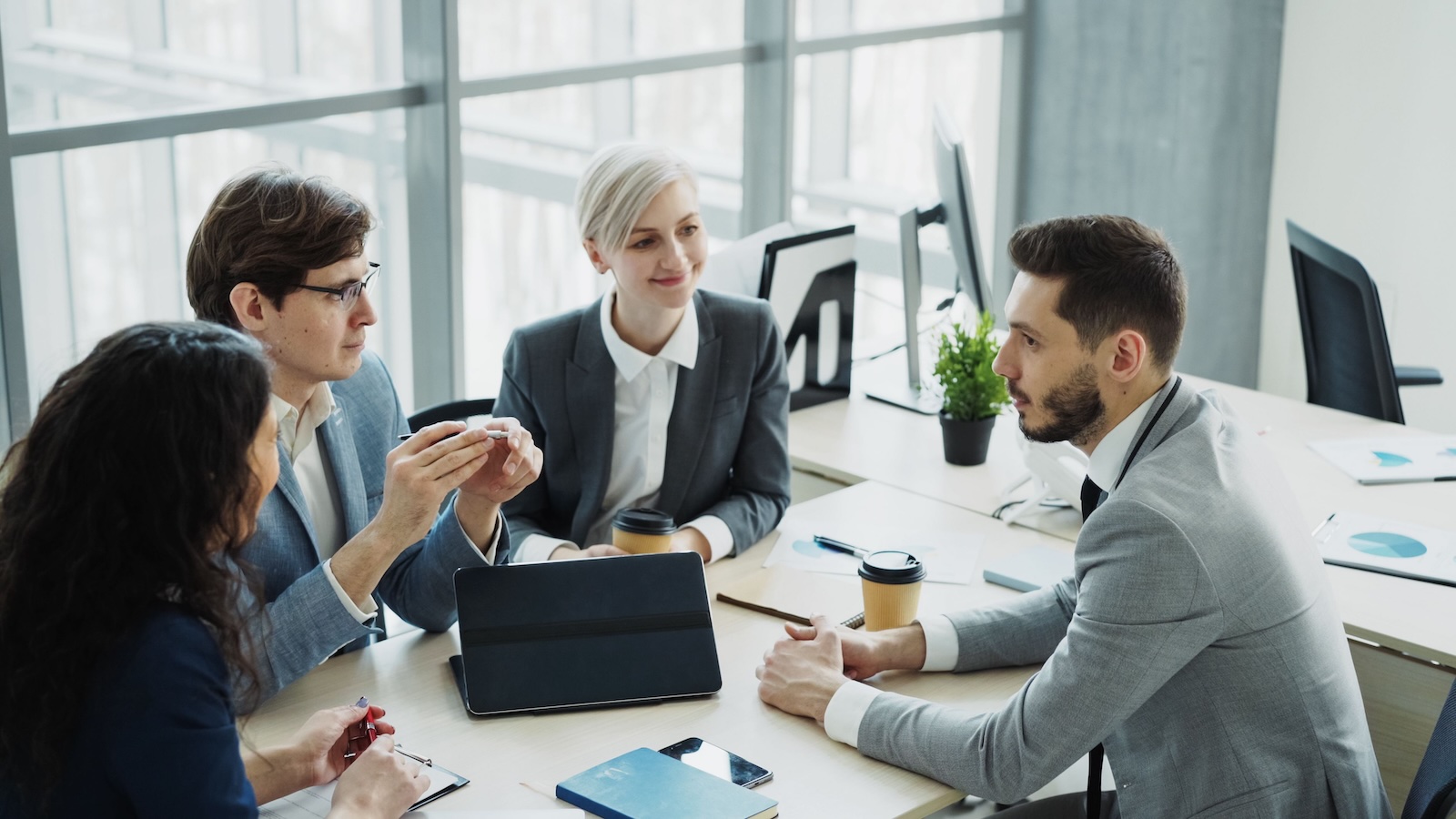 He Got a 50% Raise and Bought a Car for His New Role—Then His Company Fired Him Before He Started corporate office workers in a meeting