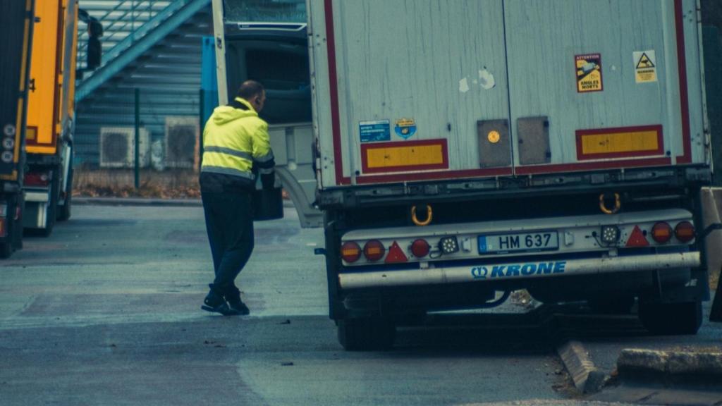 worker in safety gear unloading a truck