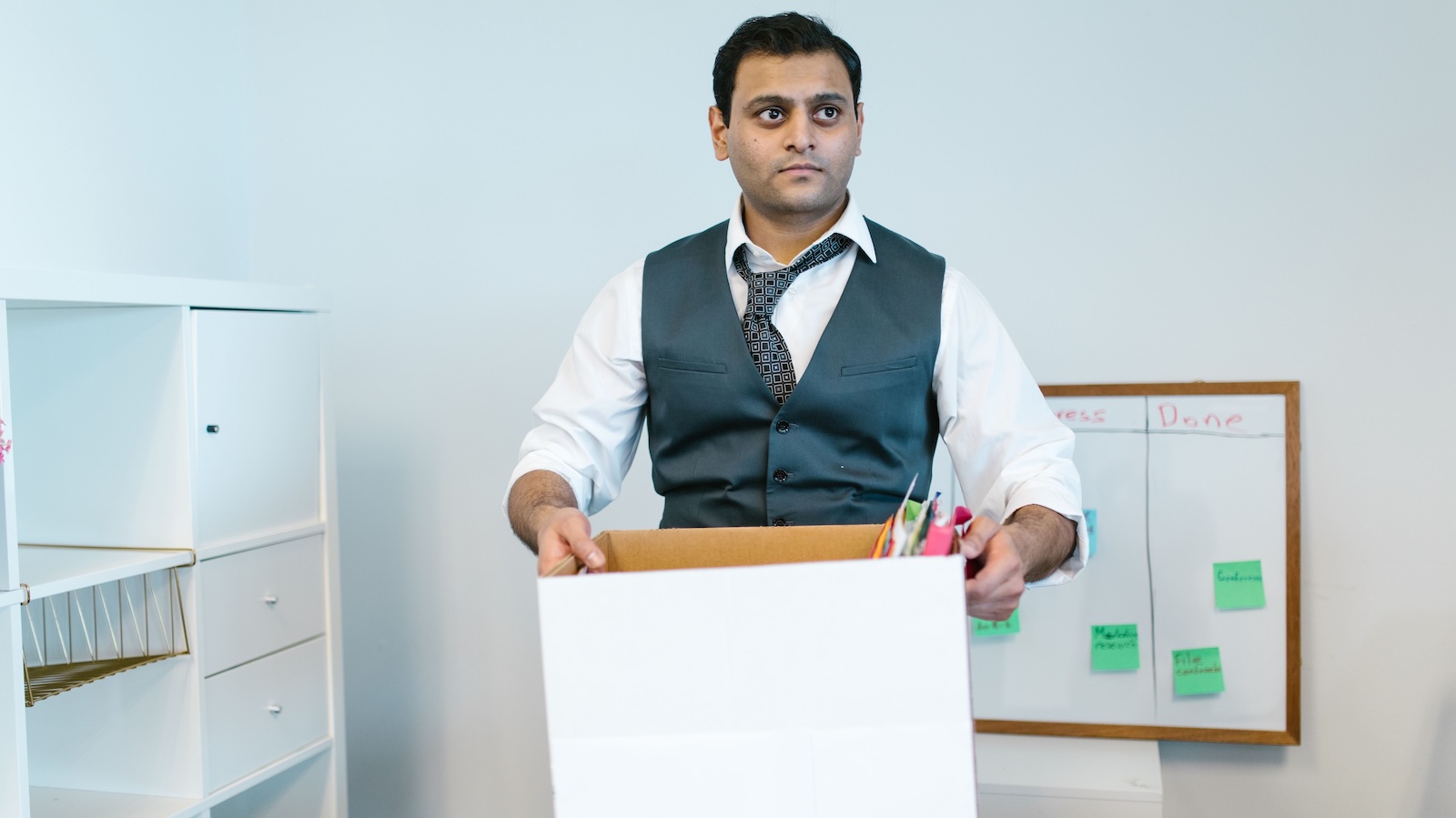 She Ran the Tutoring Center for Years—Then the New Owners Took Over and Started Belittling Her coworker holding a box