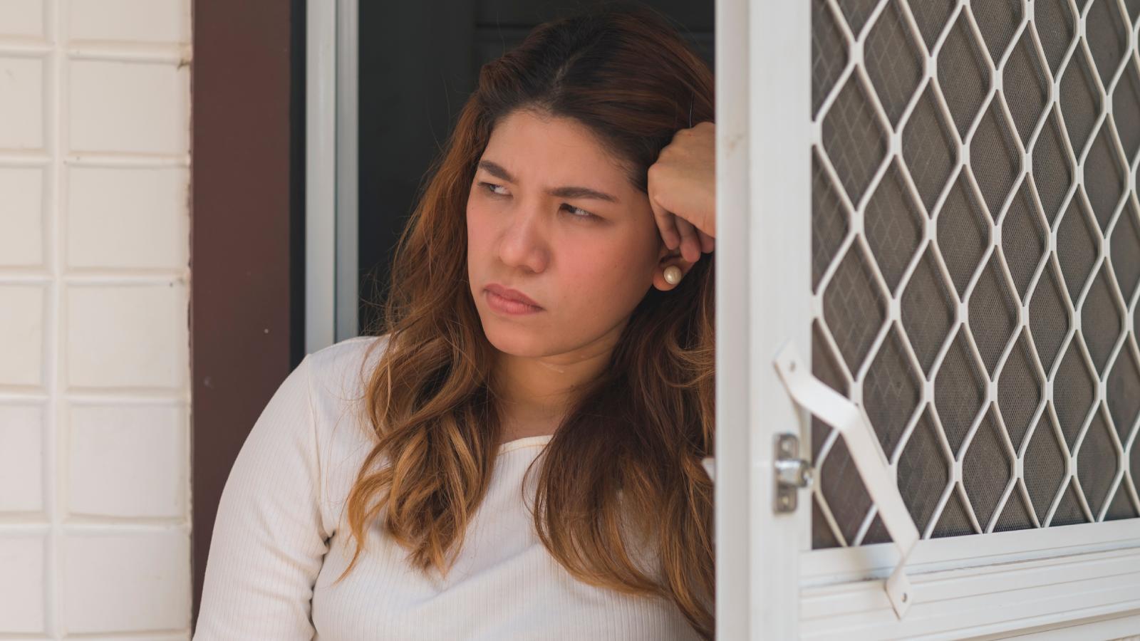 She Reported Her Neighbors for Making a Scene—So They Started Stealing Every Package Off Her Porch woman looking out her front door
