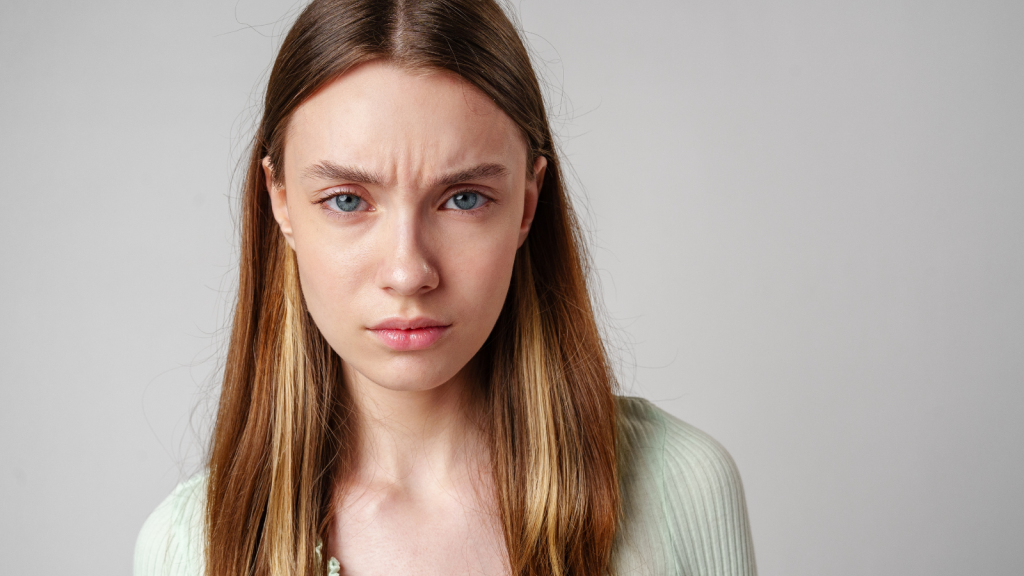 She Wanted The Employee To Respond In A Very Specific Way, But When That Didn’t Happen, She Turned The Interaction Into A Complaint young brown haired woman frowning