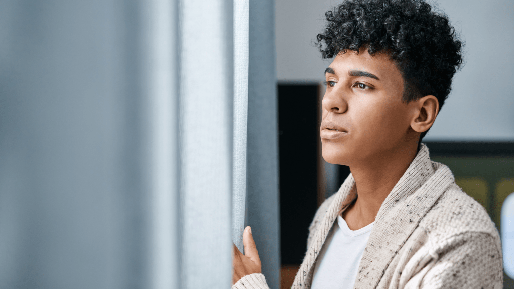 young man looking out the window