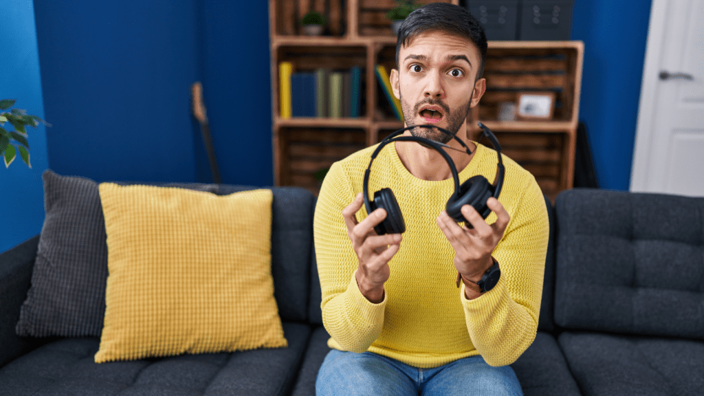 young man shocked broken headphones