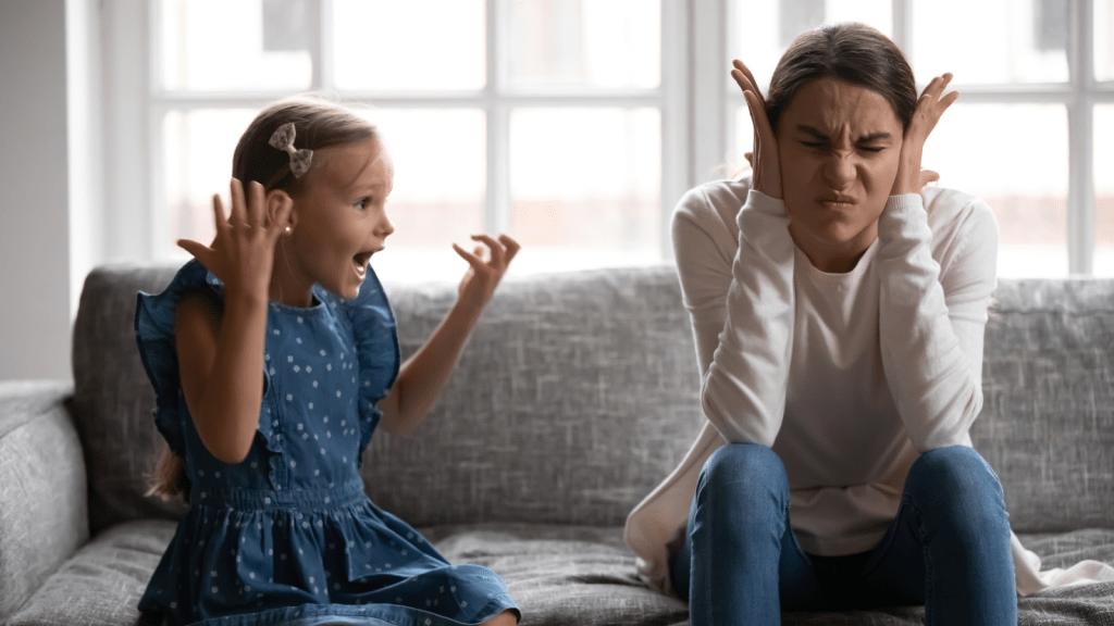young woman babysitter frustrated covering ears