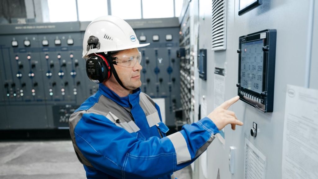 Man in uniform working in a factory