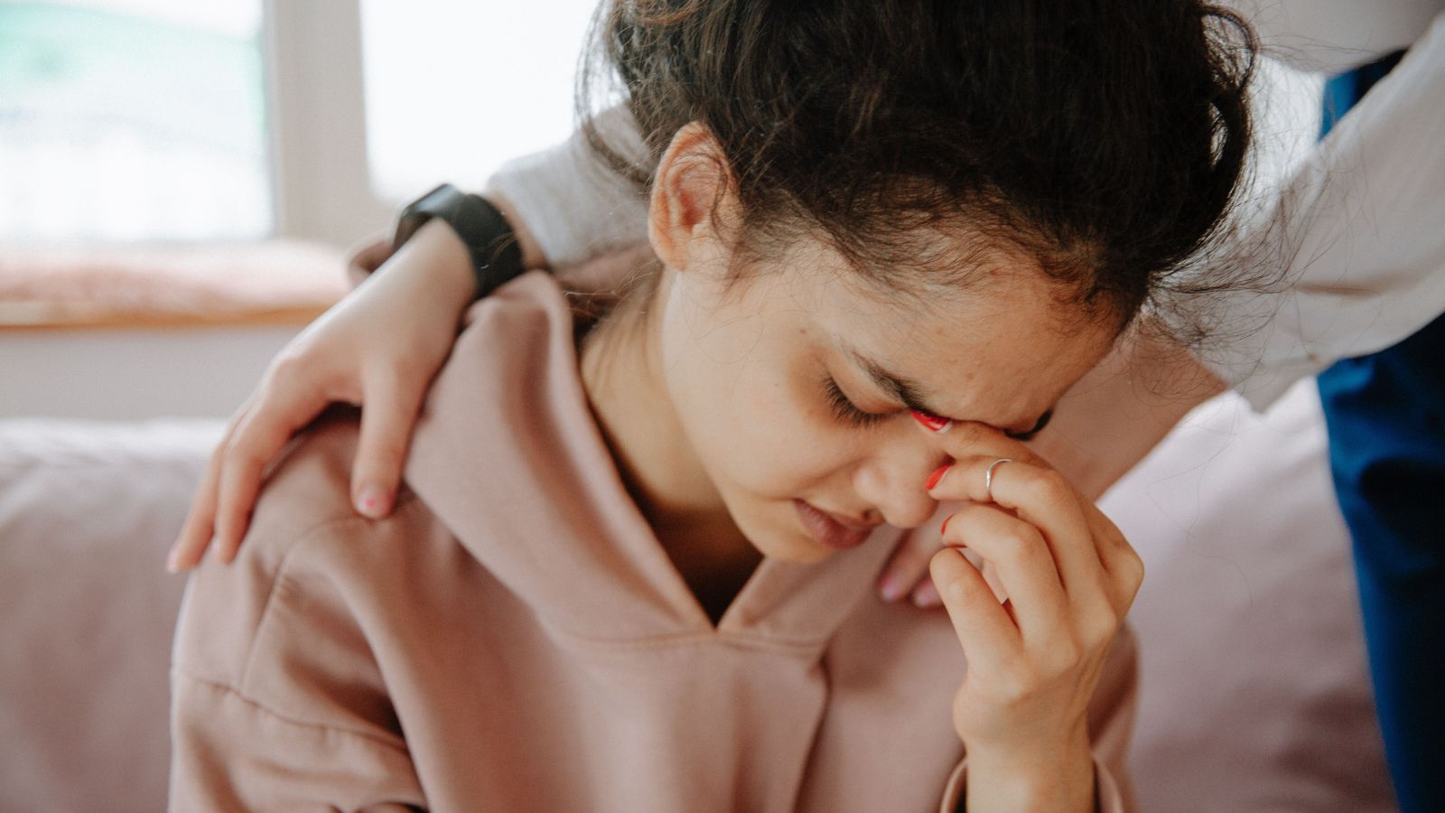 Sad girl in pink hoodie
