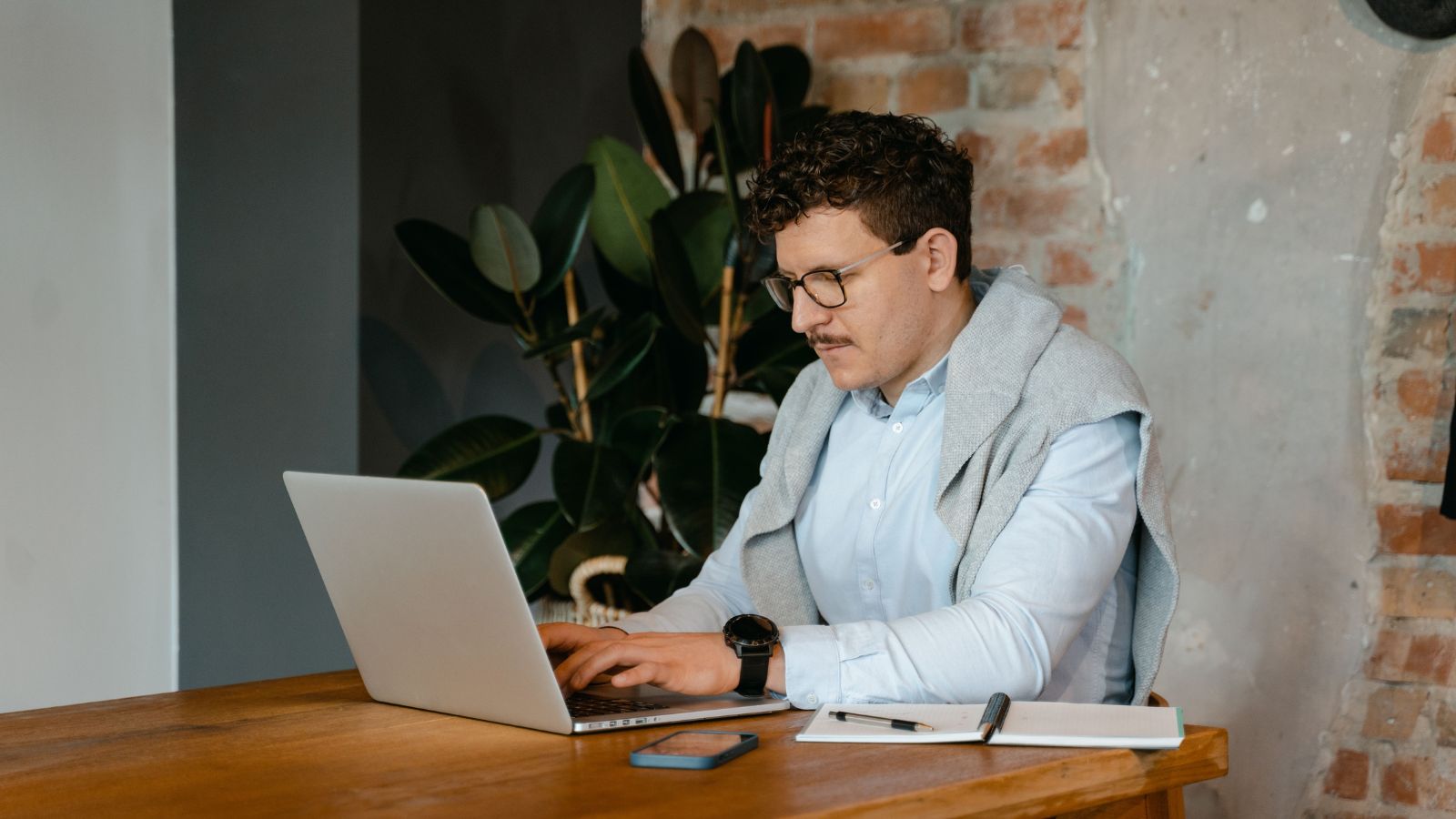 His Boss Piled On Too Much Work, And When He Asked For Help, His Boss Told Him To Just Leave β So He Did Man in blue shirt working on his laptop