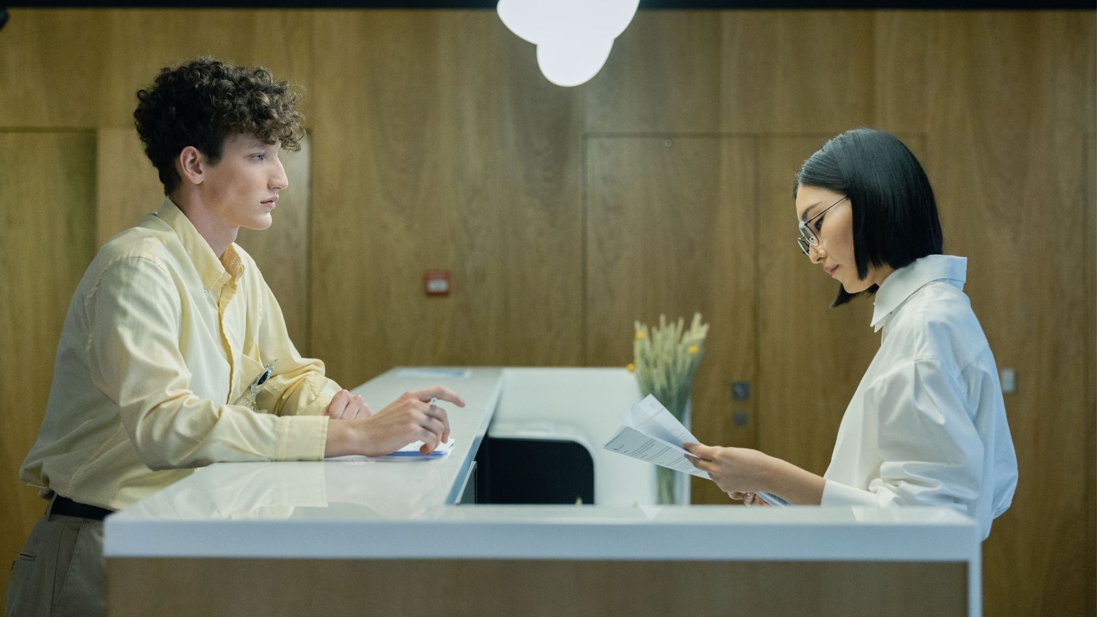 Man and woman at a front desk