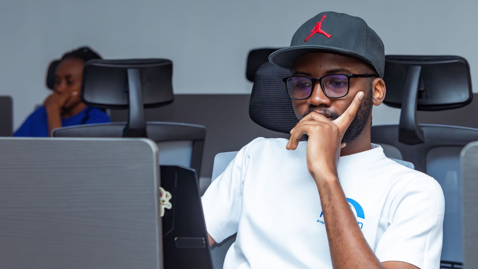 He Suggested A Simple Fix For An IT Failure At His New Job, And The Whole Office Yelled At Him β Until They Realized He Was Right Man in white shirt working on his laptop