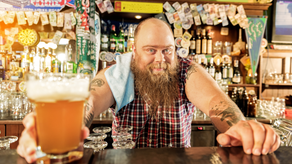 They Were Forced to Work 70 Hours a Week Covering Unfilled Roles—Then Dropped All Unassigned Duties to Work Strict Contracted Hours Bearded bartender giving a beer