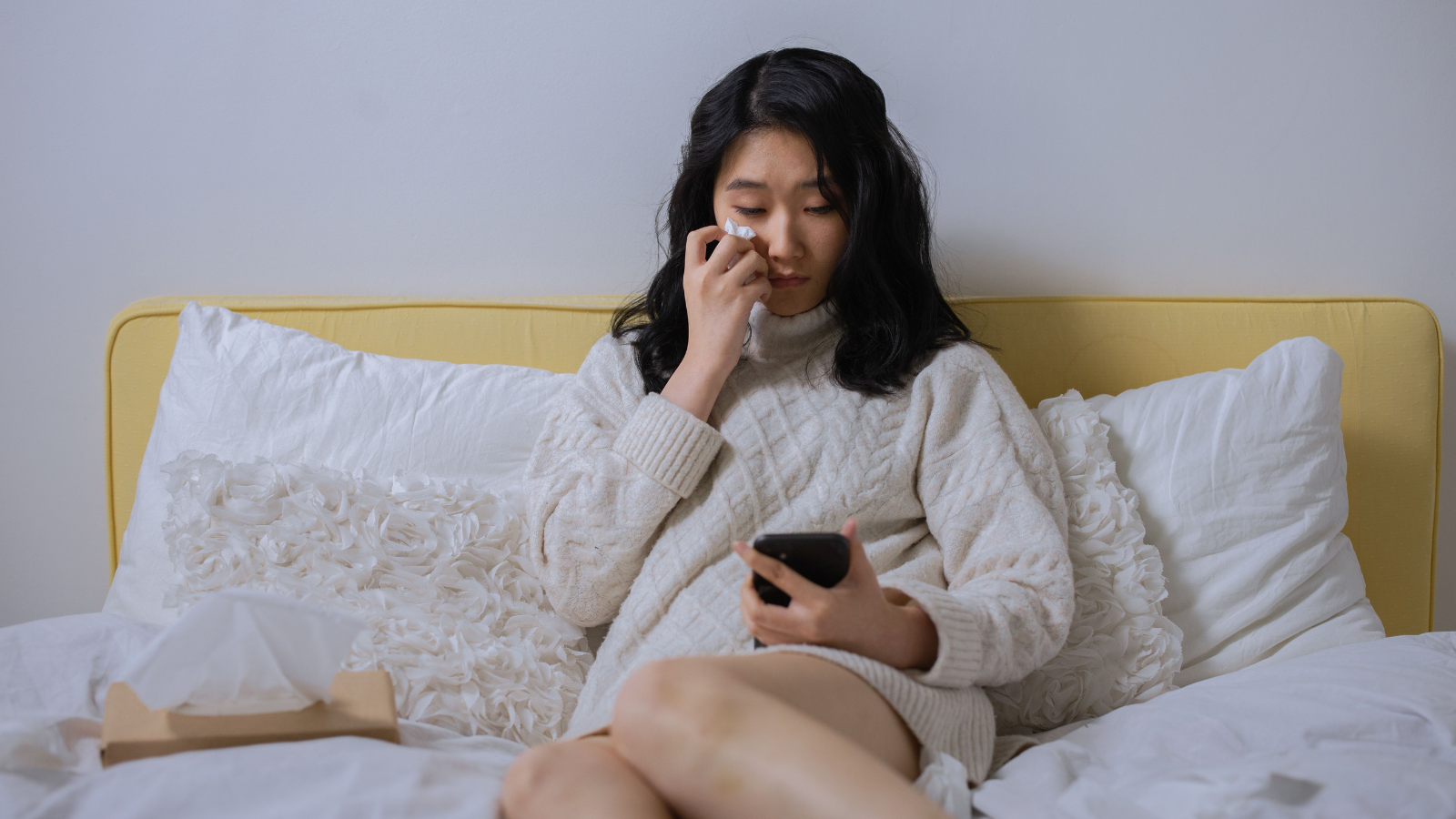A woman texting and crying