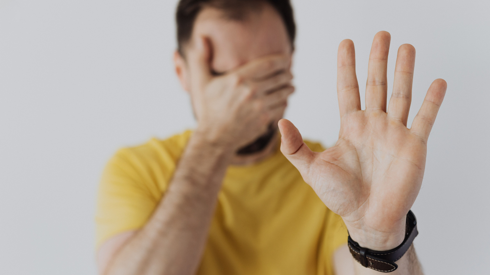 A guy with his hand on his face